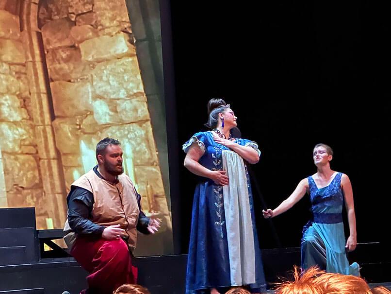 Zak performing on stage in an opera production